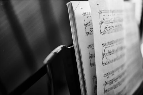 black and white sheet music on a stand