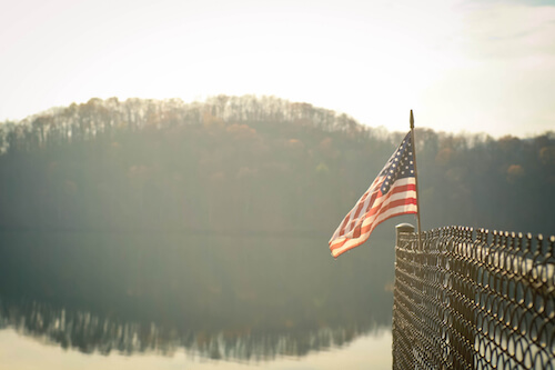 American flag over a lake