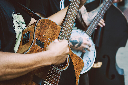 Street musicians playing banjo, guitar and double bass.