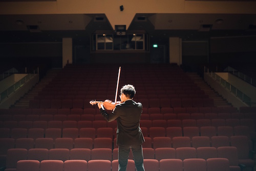 Young violinist performing on stage